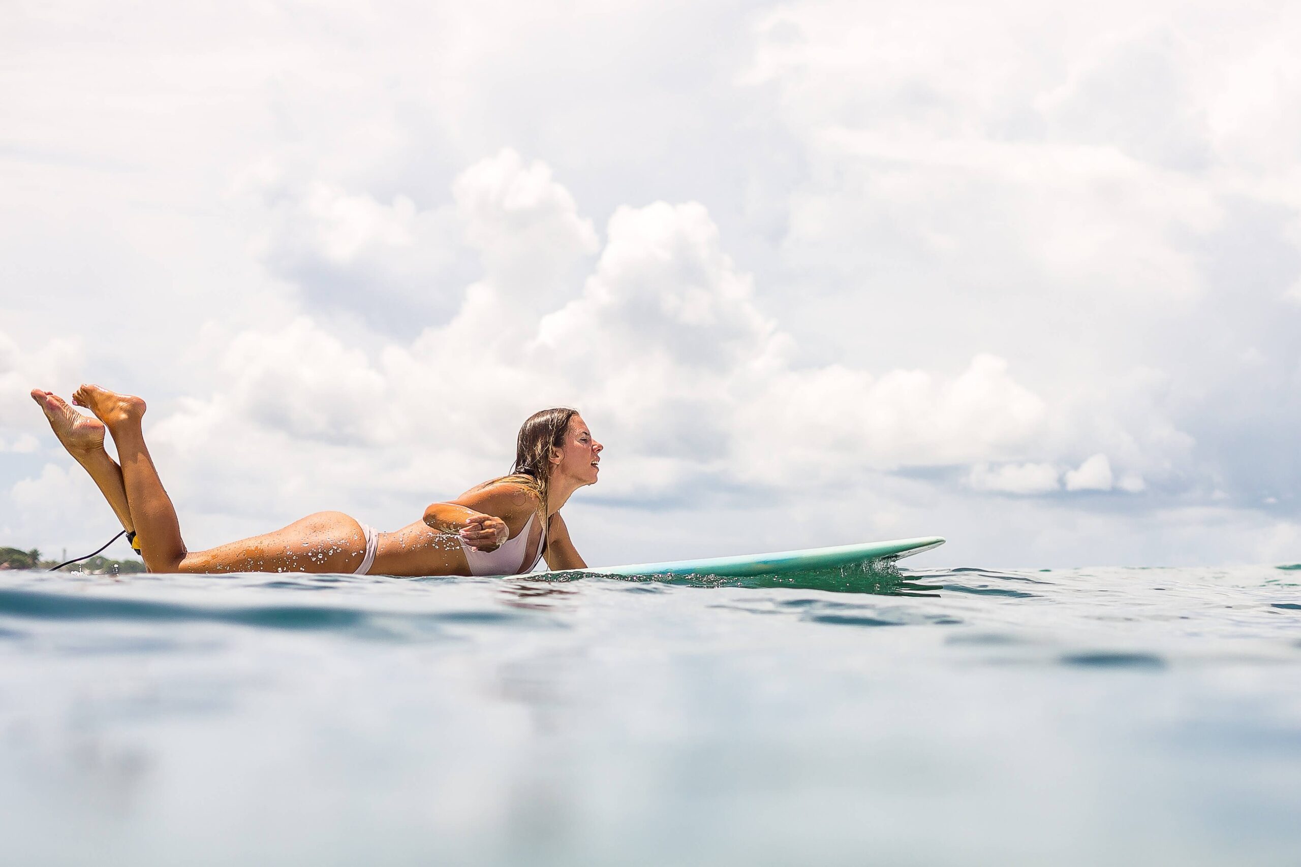A woman learning how to surf in Hawaii.